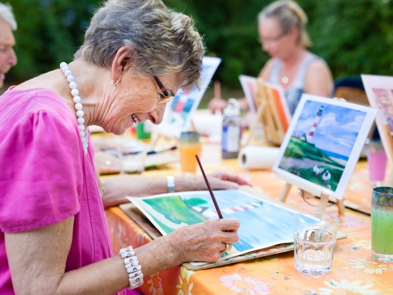 Side,View,Of,A,Happy,Senior,Woman,Smiling,While,Drawing